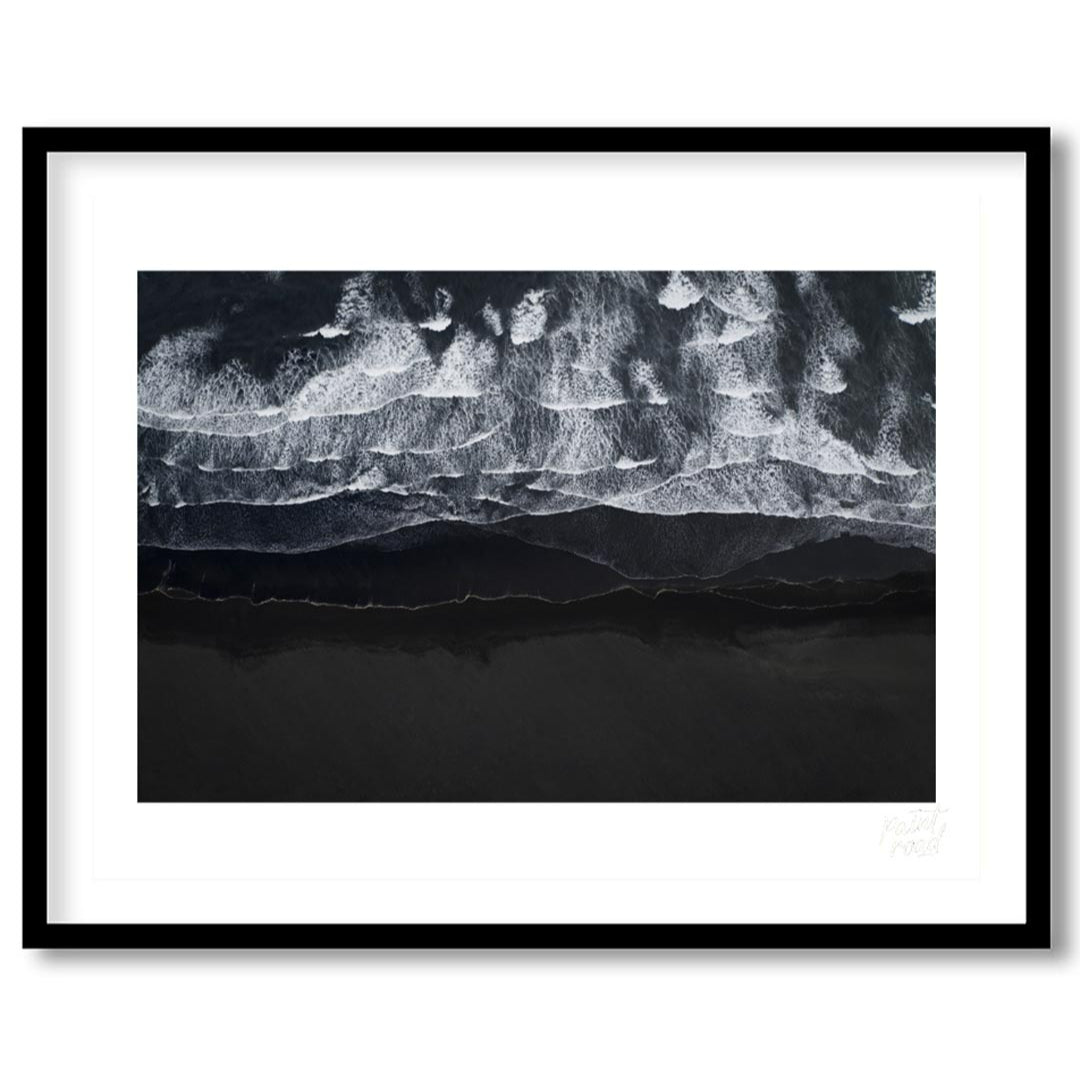 This stunning aerial photograph captures the dramatic beauty of a black sand beach, likely in Icela… for home