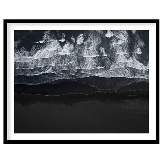 This stunning aerial photograph captures the dramatic beauty of a black sand beach, likely in Icela… for home