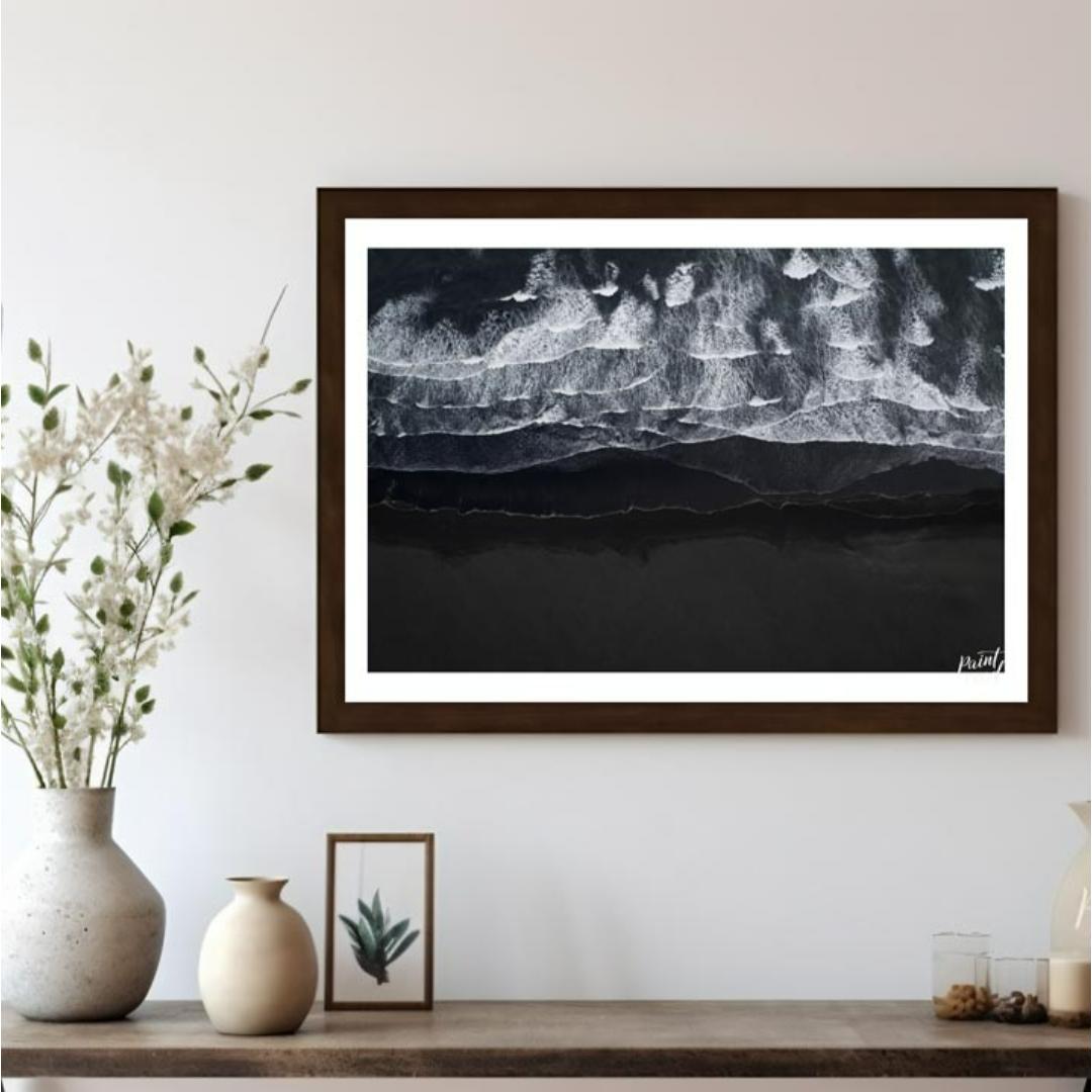 This stunning aerial photograph captures the dramatic beauty of a black sand beach, likely in Icela… for living room