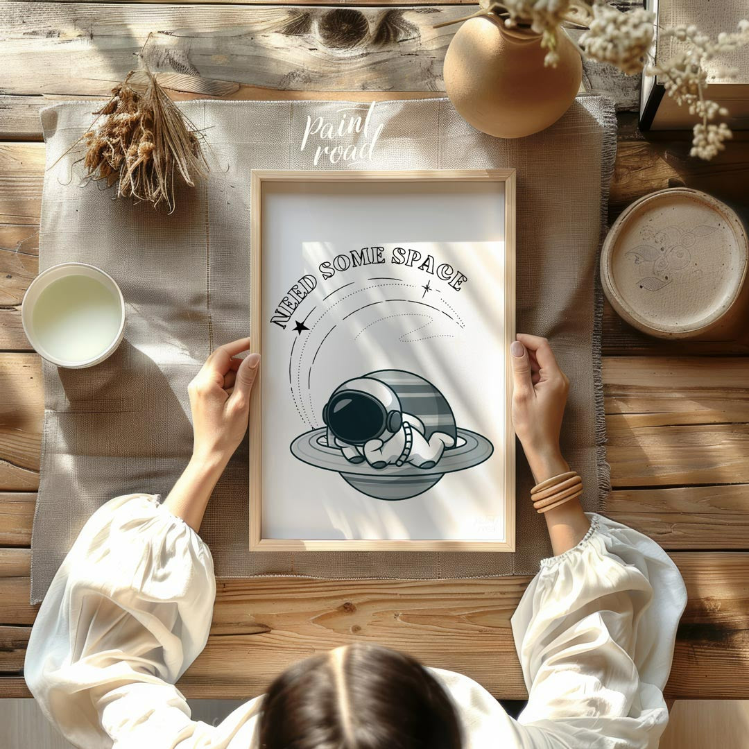 This whimsical design features a cartoon astronaut lounging effortlessly on the rings of Saturn, ne… for other