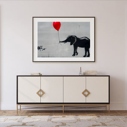 This captivating artwork features a playful monochrome elephant juxtaposed with a striking red for Foyer