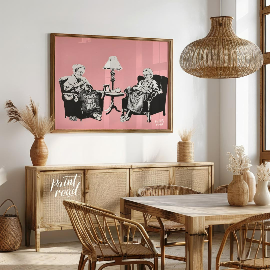 This iconic Banksy print, titled “Grannies,” features two elderly women seated in armchairs, dilige… for dining room