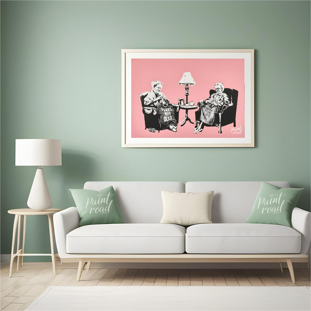 This iconic Banksy print, titled “Grannies,” features two elderly women seated in armchairs, dilige… for living room