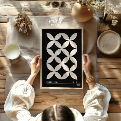 This high-contrast Bauhaus poster presents a captivating pattern of white petal-like shapes forming… for dining room
