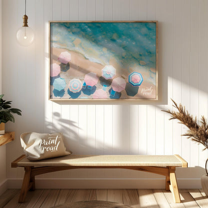 This aerial photograph captures a serene beach scene, showcasing a collection of pastel-colored par… for entryway