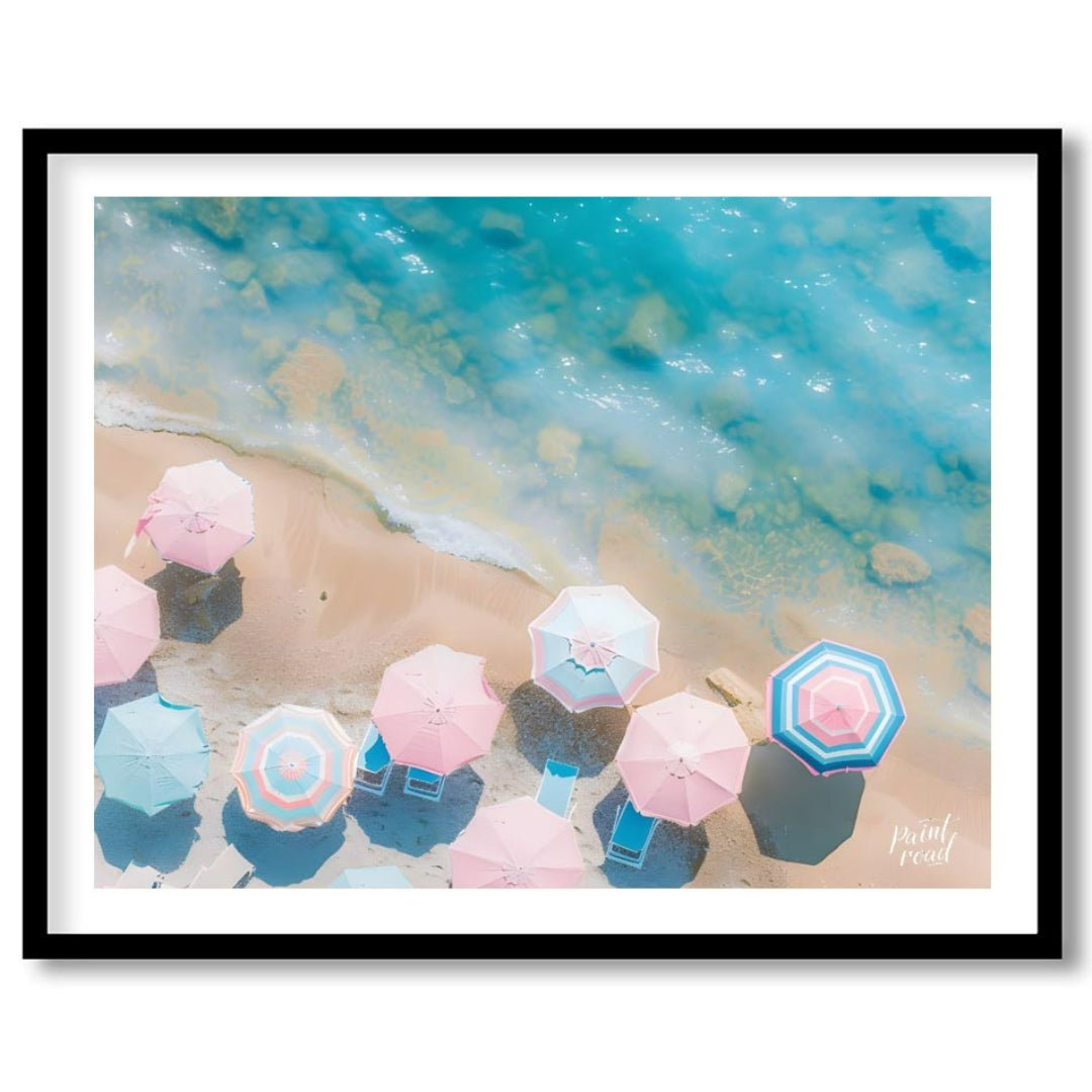This aerial photograph captures a serene beach scene, showcasing a collection of pastel-colored par… for home