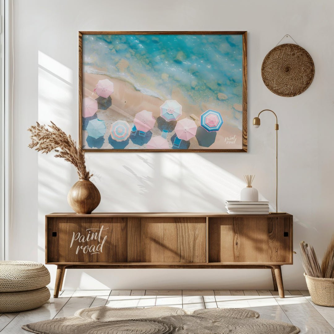 This aerial photograph captures a serene beach scene, showcasing a collection of pastel-colored par… for living room