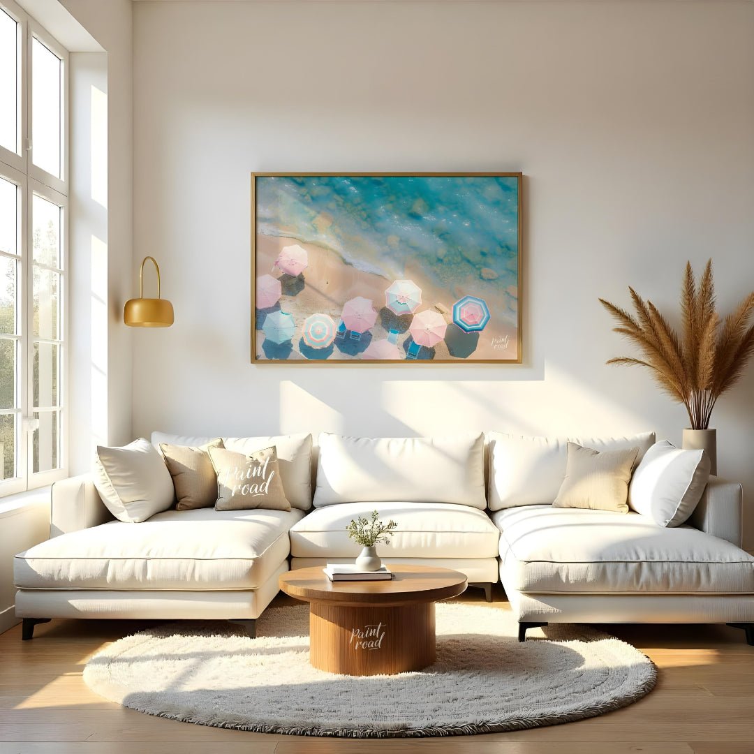 This aerial photograph captures a serene beach scene, showcasing a collection of pastel-colored par… for living room