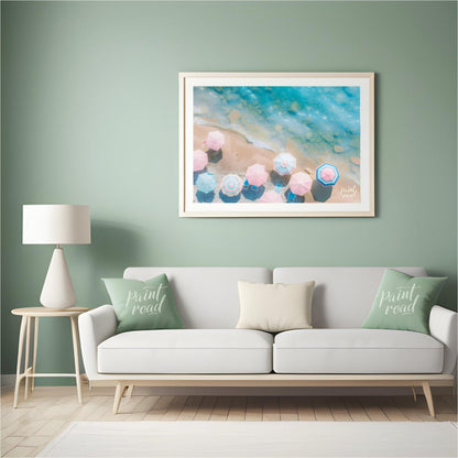 This aerial photograph captures a serene beach scene, showcasing a collection of pastel-colored par… for living room