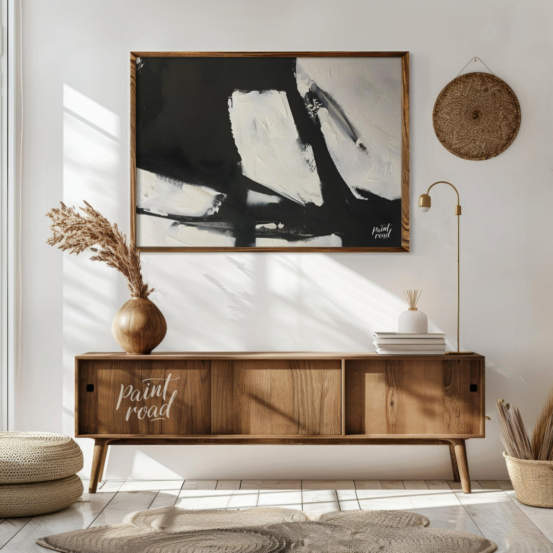 This abstract painting features a dynamic interplay of stark black and white shapes, creating a sen… for living room