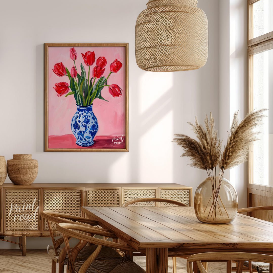 This artwork features a vibrant bouquet of red tulips arranged in a classic blue and white patterne… for dining room