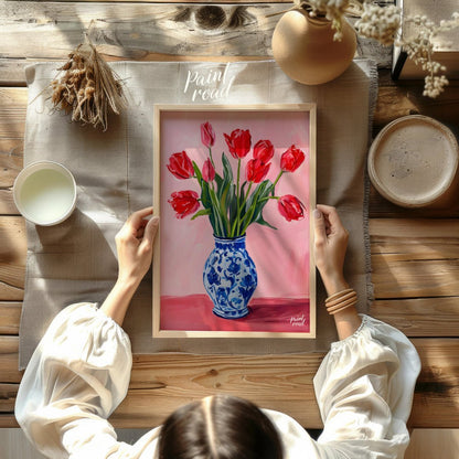 This artwork features a vibrant bouquet of red tulips arranged in a classic blue and white patterne… for other