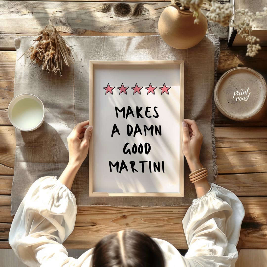 A fun and playful graphic design featuring the phrase "Makes a Damn Good Martini" written in a bold… for dining room