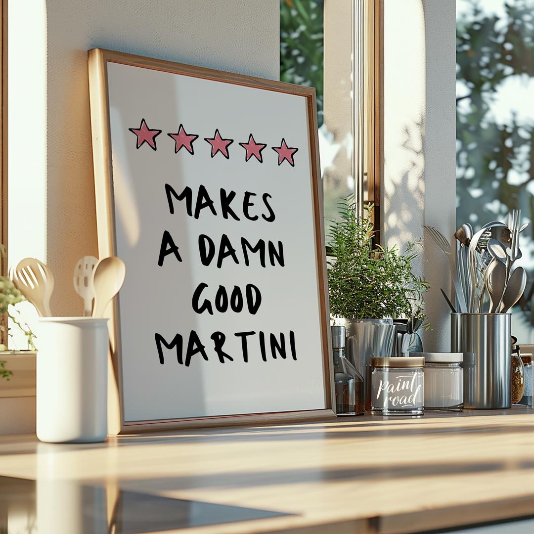 A fun and playful graphic design featuring the phrase "Makes a Damn Good Martini" written in a bold… for kitchen