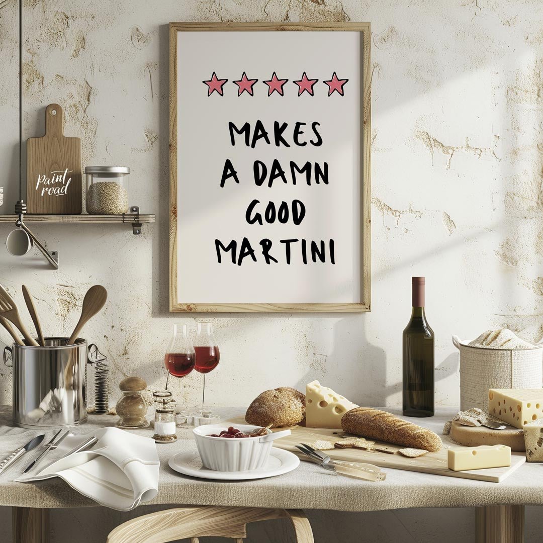 A fun and playful graphic design featuring the phrase "Makes a Damn Good Martini" written in a bold… for kitchen