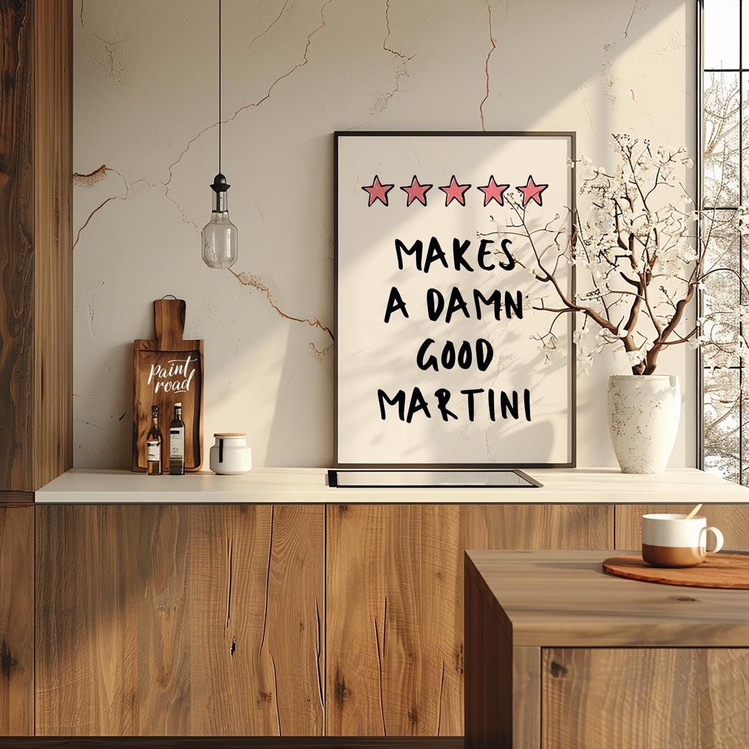 A fun and playful graphic design featuring the phrase "Makes a Damn Good Martini" written in a bold… for kitchen