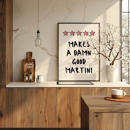 A fun and playful graphic design featuring the phrase "Makes a Damn Good Martini" written in a bold… for kitchen