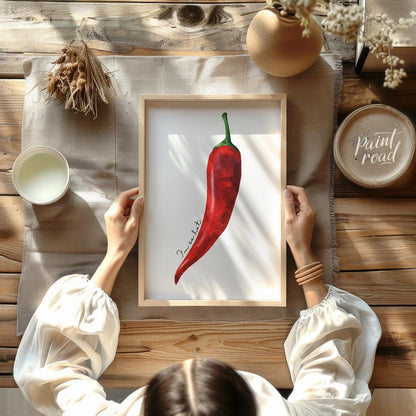 This striking minimalist poster features a single, vibrant red chili pepper rendered in a realistic… for dining room
