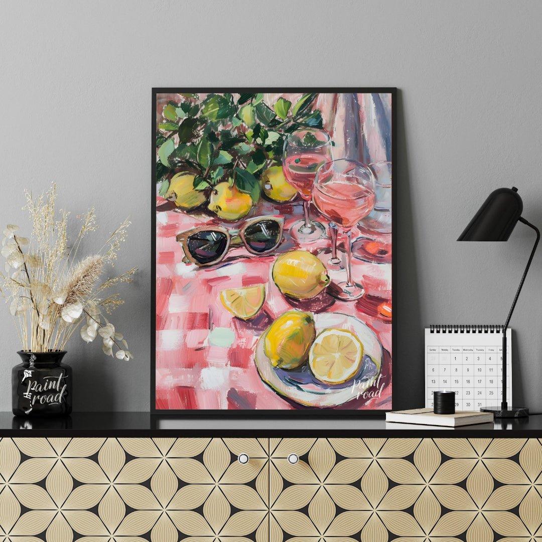 This charming painting captures a sun-drenched picnic scene, featuring ripe lemons, rosé wine glass… for living room