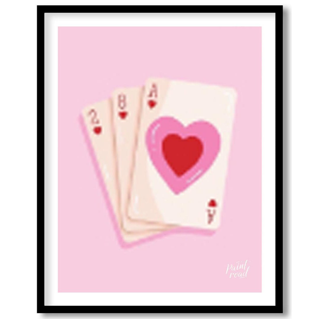 This charming and subtly romantic print features a hand of playing cards against a soft pink backgr… for home