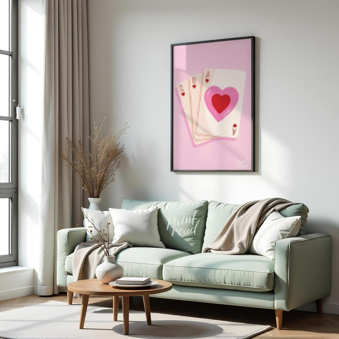 This charming and subtly romantic print features a hand of playing cards against a soft pink backgr… for living room