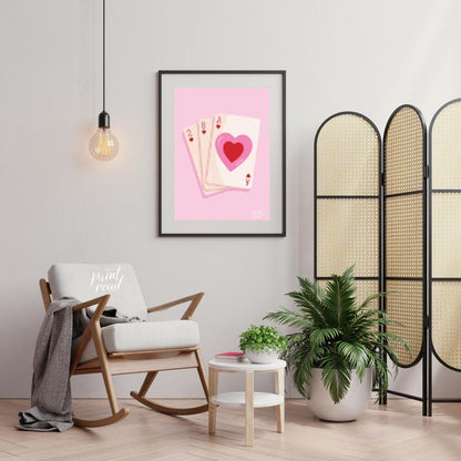 This charming and subtly romantic print features a hand of playing cards against a soft pink backgr… for living room