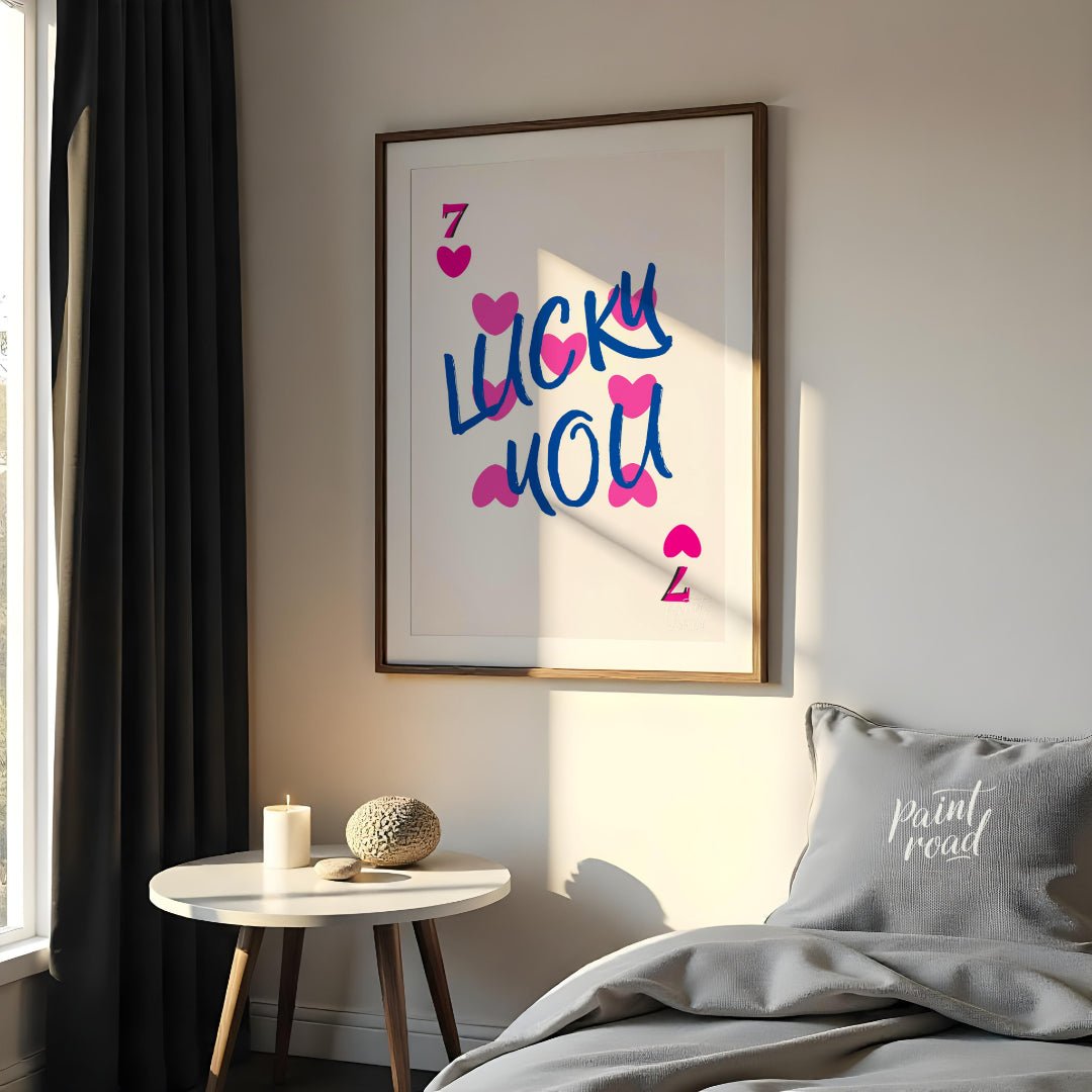 This playful and visually striking graphic features the phrase “LUCKY YOU” in bold, brushstroke-sty… for bedroom