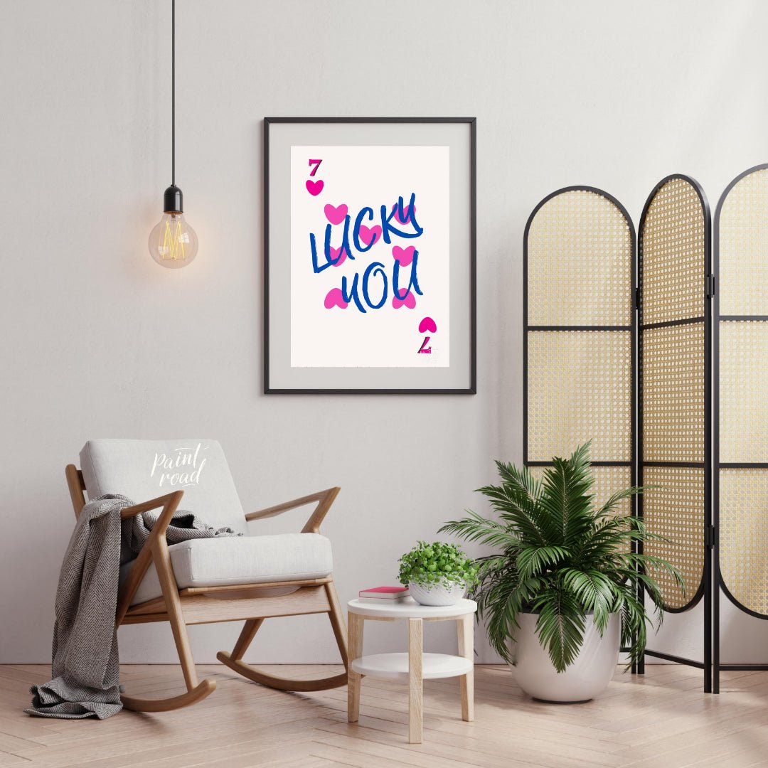 This playful and visually striking graphic features the phrase “LUCKY YOU” in bold, brushstroke-sty… for living room