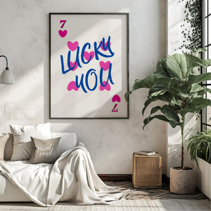 This playful and visually striking graphic features the phrase “LUCKY YOU” in bold, brushstroke-sty… for living room