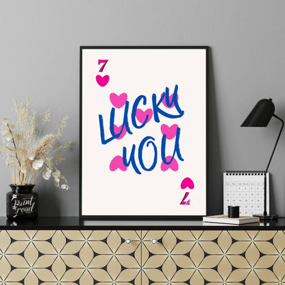 This playful and visually striking graphic features the phrase “LUCKY YOU” in bold, brushstroke-sty… for office