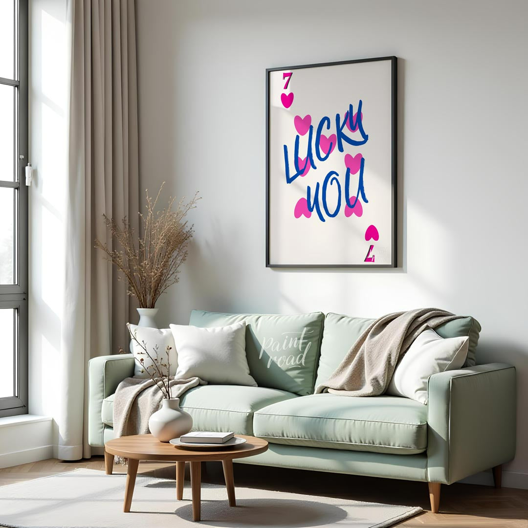 This playful and charming print features the phrase “LUCKY YOU” in a bold, hand-drawn blue script, … for living room