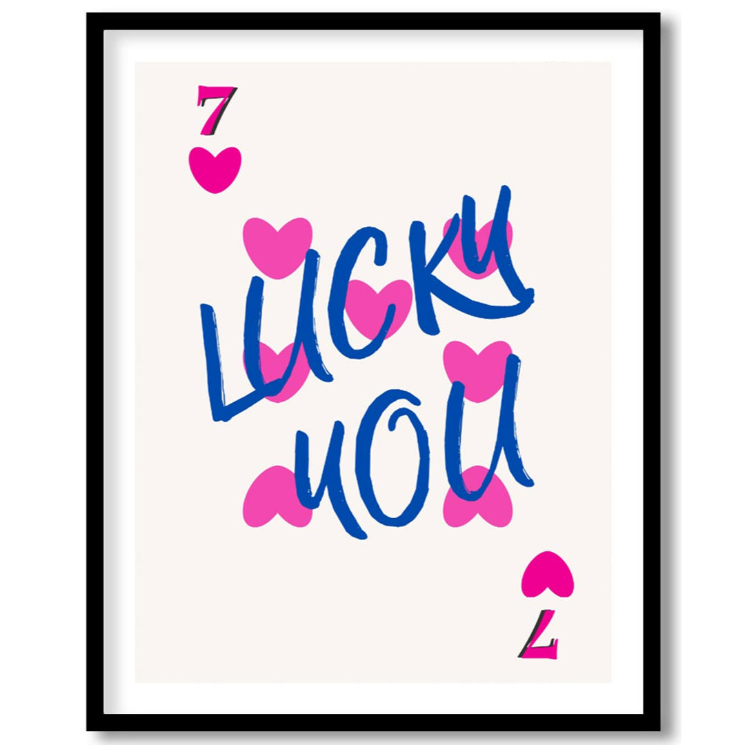 This playful and charming print features the phrase “LUCKY YOU” in a bold, hand-drawn blue script, … for place