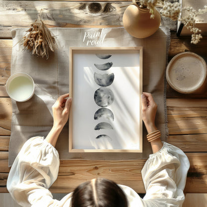 """Lunar Phases"" presents a delicate watercolor rendering of the moon's cycle, depicted in a verti… for dining room