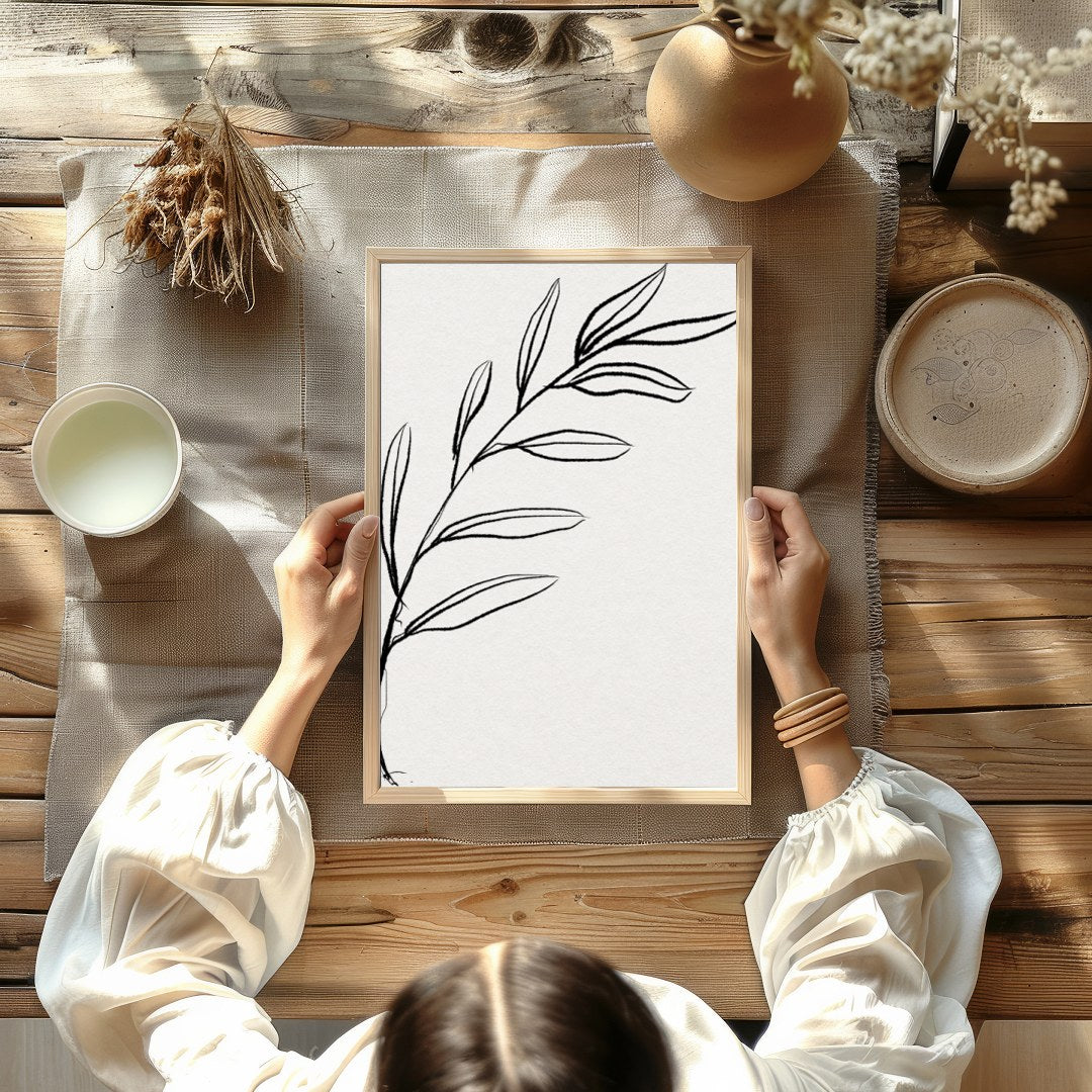 This elegant piece features a minimalist depiction of a botanical element in delicate lines. Its for Kitchen
