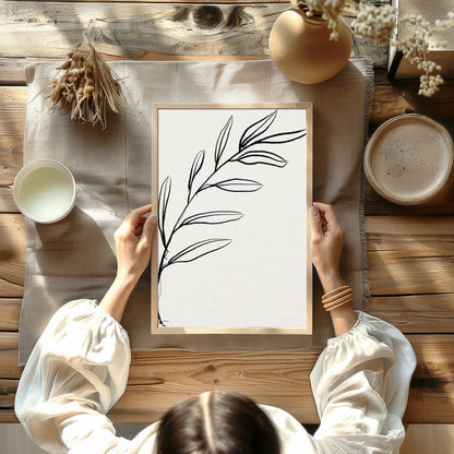 This elegant piece features a minimalist depiction of a botanical element in delicate lines. Its for Kitchen