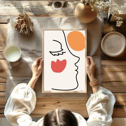 This elegant wall art piece features a minimalist line drawing of a face, juxtaposed with bold for Kitchen