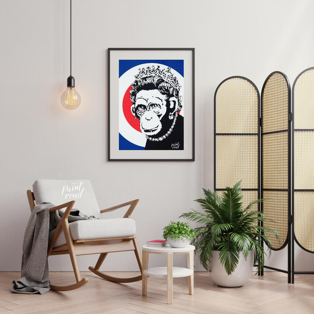 This provocative art print features Banksy’s “Monkey Queen” stencil, portraying Queen Elizabeth II … for living room