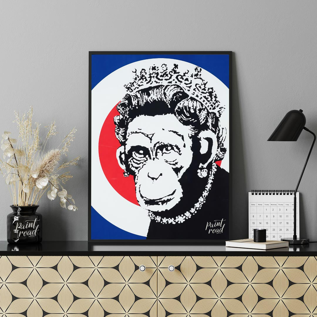 This provocative art print features Banksy’s “Monkey Queen” stencil, portraying Queen Elizabeth II … for office