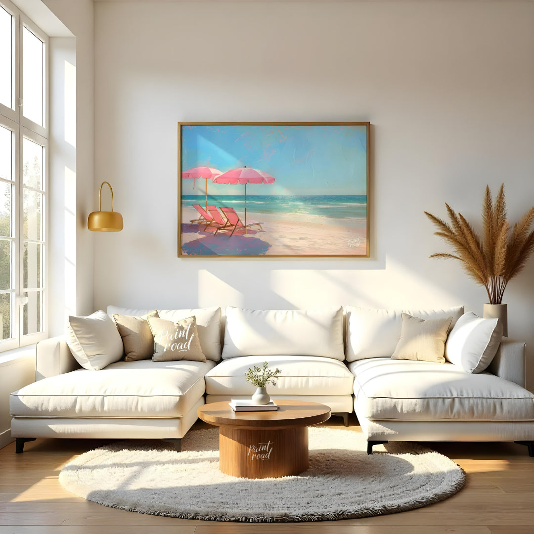 This artwork captures a tranquil beach scene with two pink parasols and matching lounge chairs set … for living room