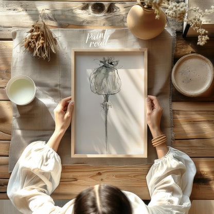 """Poppy Sketch"" presents a delicate, minimalist rendering of a poppy flower in ink on paper. The … for other