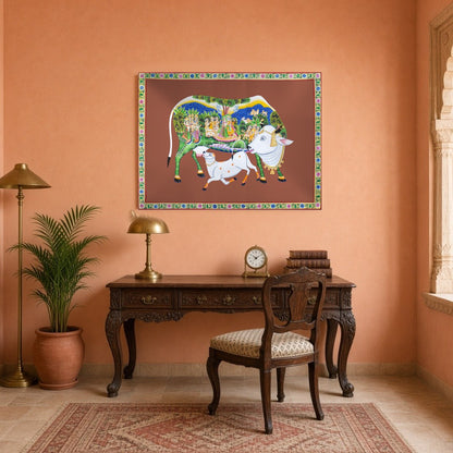 Immerse yourself in the sanctity and beauty of this Pichwai artwork featuring the revered Kamdhenu for Study