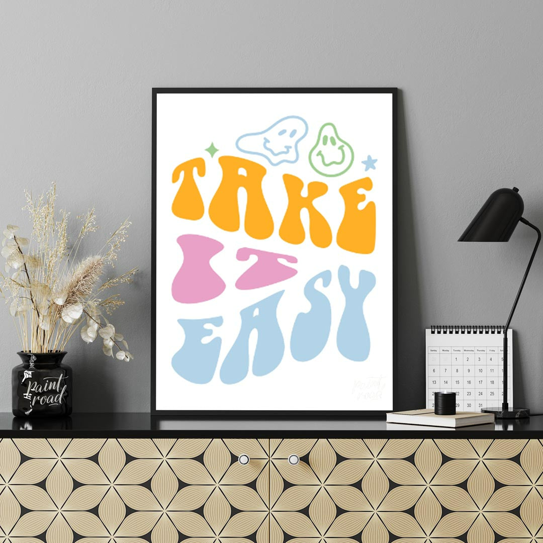 This vibrant and retro-inspired artwork features the phrase “TAKE EASY” in a bold, wavy, and whimsi… for living room