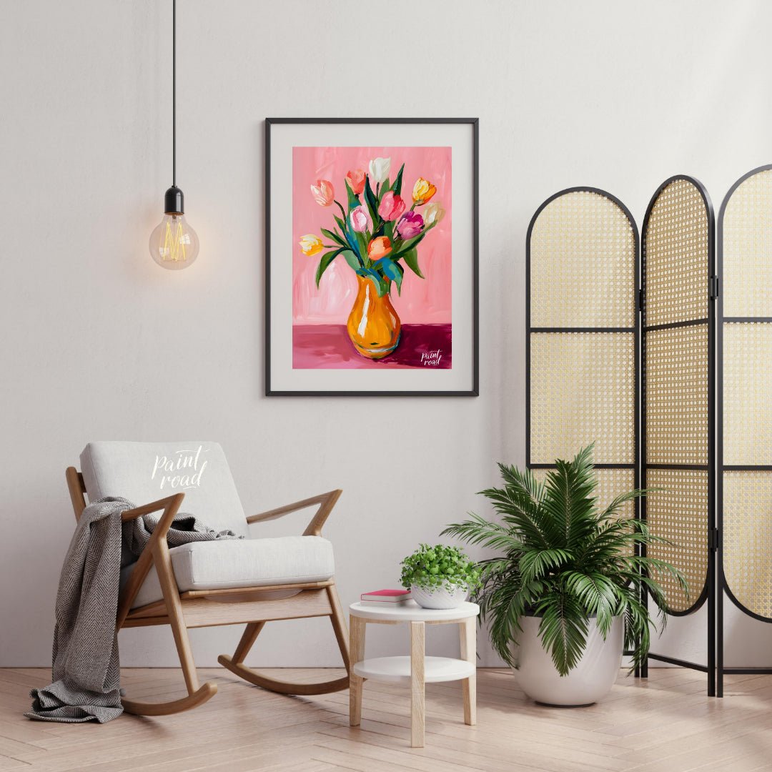 This charming artwork features a bouquet of tulips in a vibrant orange vase, set against a soft pin… for living room